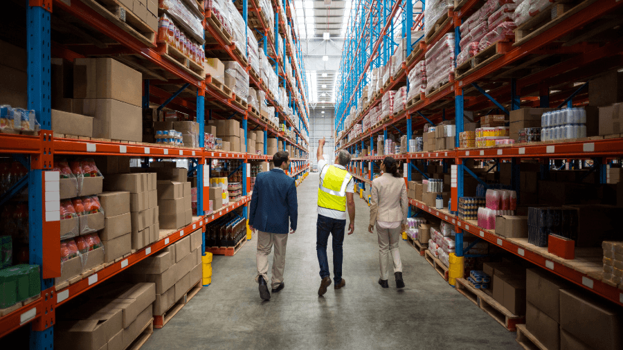 Site Manager and clients walking through warehouse