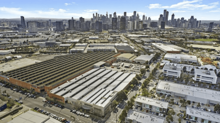 Aerial view of inner city industrial area with cityscape in the background