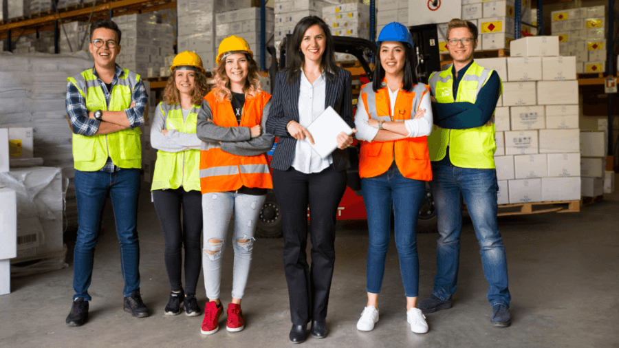 Manager standing with warehouse team