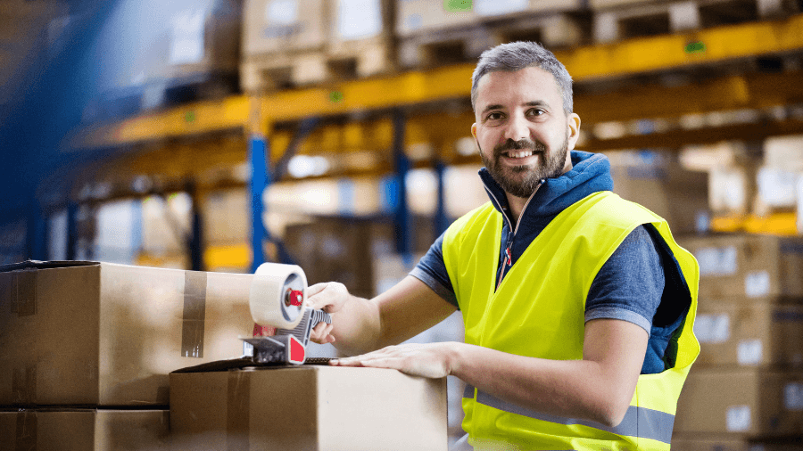 Person taping up a box in a warehouse
