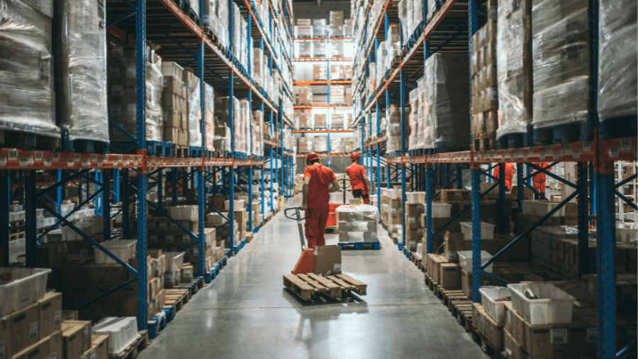 Two warehouse workers picking orders in warehouse