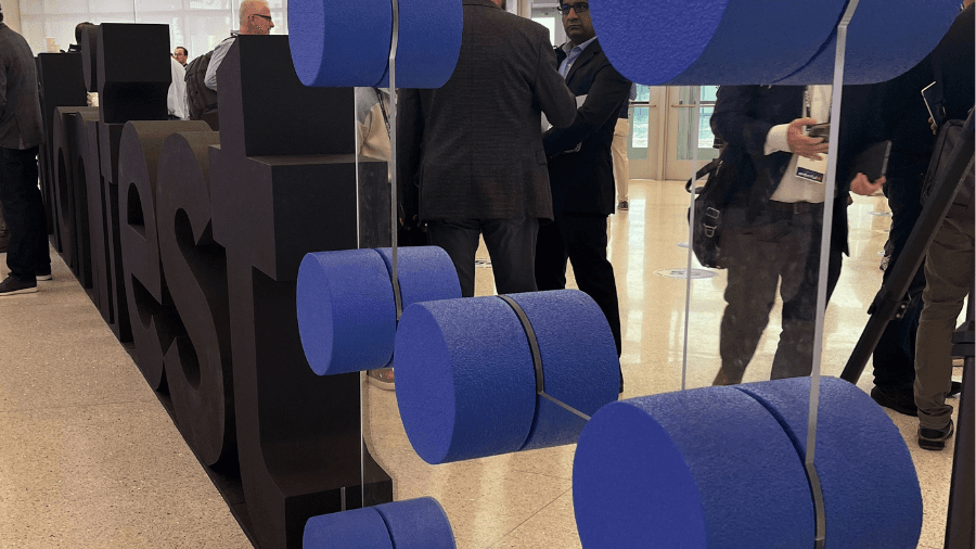 Photo of Manifest sign at entrance of Manifest Vegas 2024 conference, with people in the background
