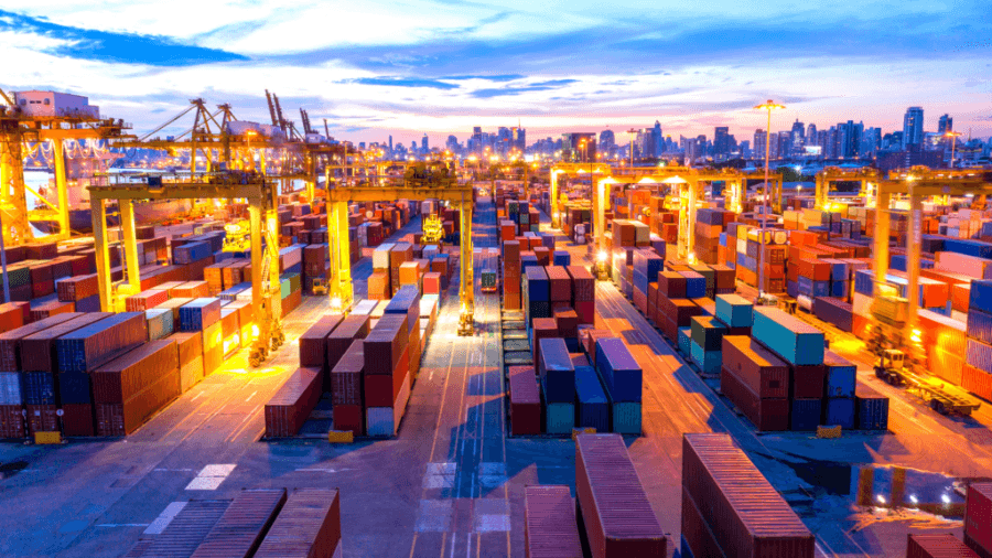 a photo of shipping containers stacked at a Port terminal