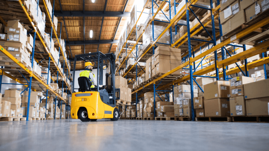 Person operating forklift in a warehouse