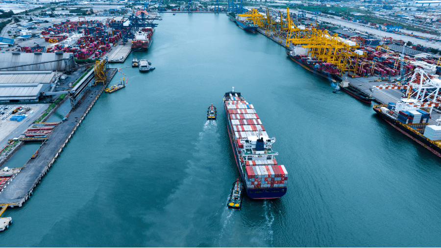 Container ship moving through canal at Port Terminal